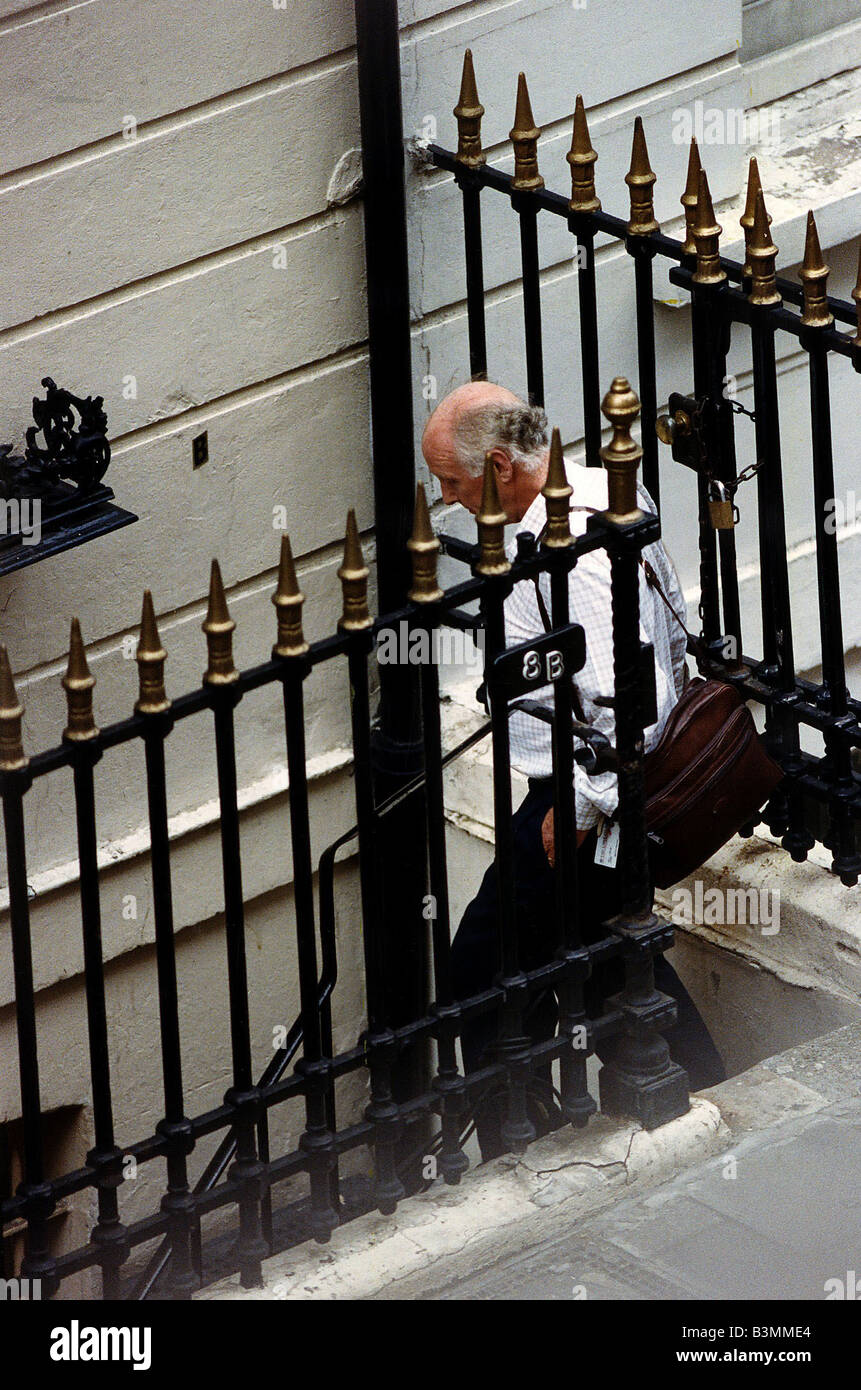 Frank Bough TV presenter is seen going down stairs to basement entrance to the London Vice Den where Miss Whiplash abuses clients in a torture chamber packed with transvestite and bondage gear Stock Photo