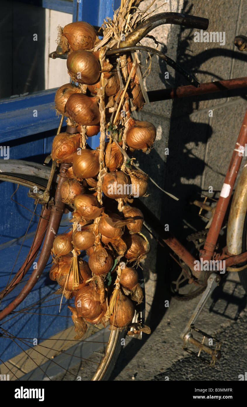 France Brittany Roscoff Bike and onions as seen in a street of Roscoff Stock Photo
