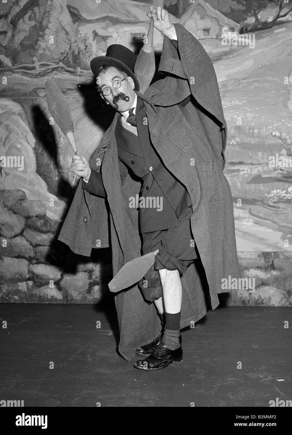 Comedian Eddie Gray seen here holding skittles wearing a false moustache Comic Juggler On stage 1948 Stock Photo