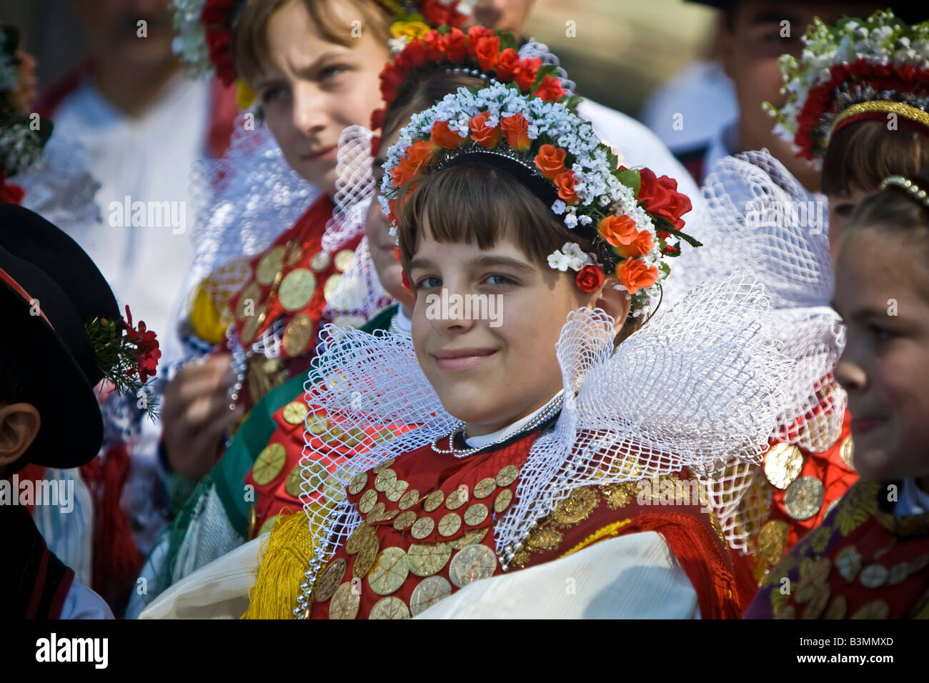 Young girl in the Croatian traditional dress with ducats on the dress and headdress on a folklore festival in Croatia. Stock Photo