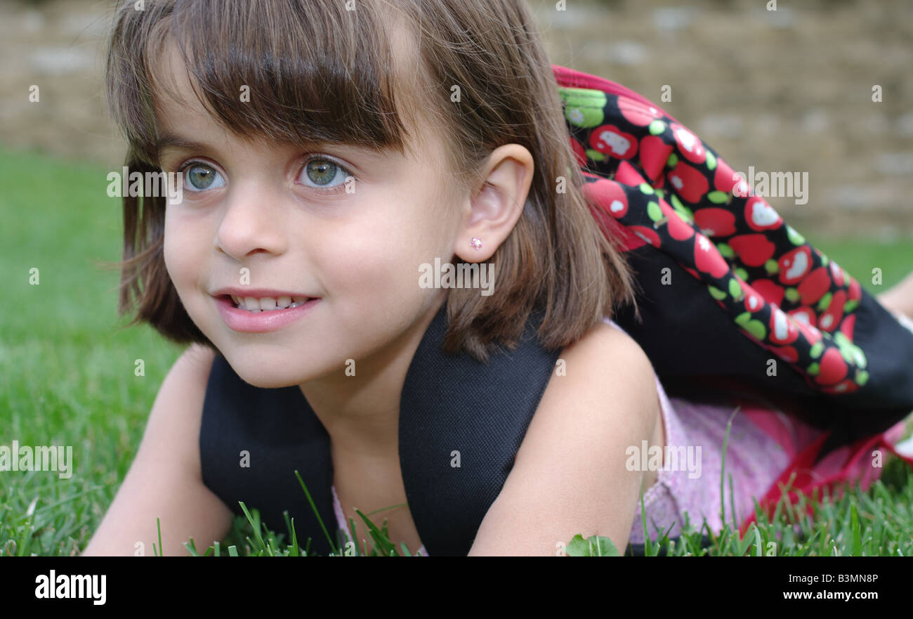 5 years old girl with backpack waiting for the start of kindergarten