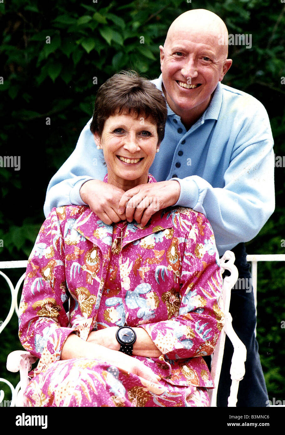 Roy Castle TV Presenter standing behind wife in garden Stock Photo - Alamy