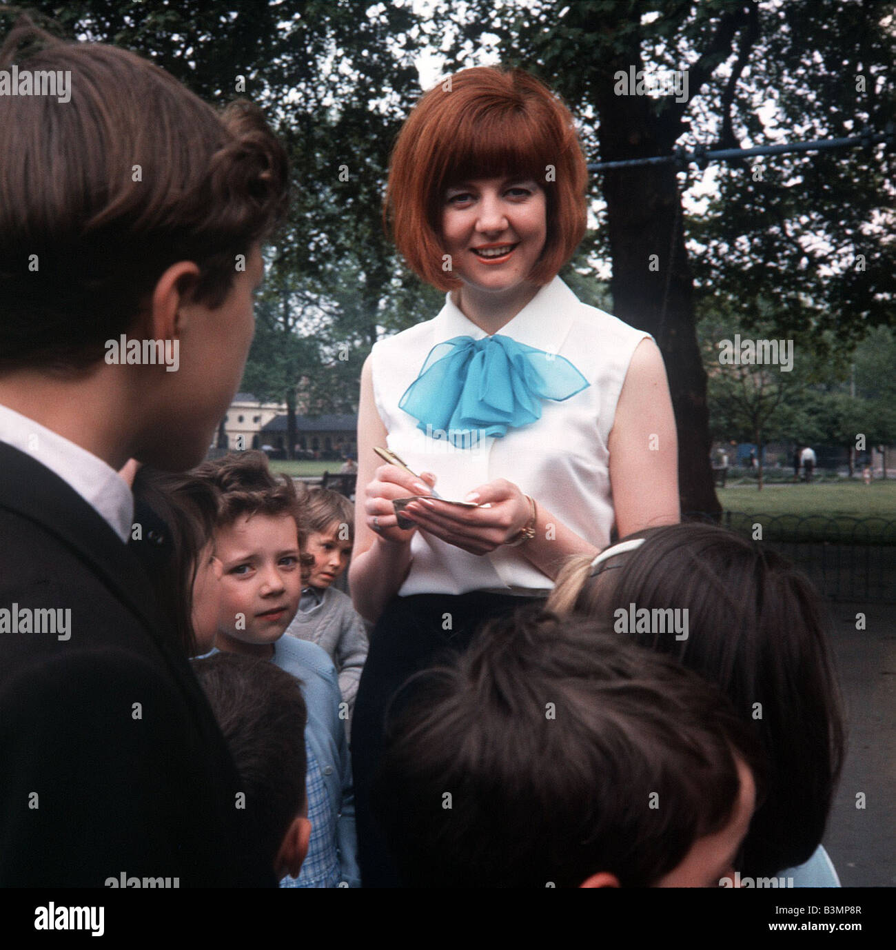 Cilla Black Singer Tv Presenter Stands Signing Autographs For Young Children Cilla Black Singer Tv Presenter Stands Signing Autographs For Young Children