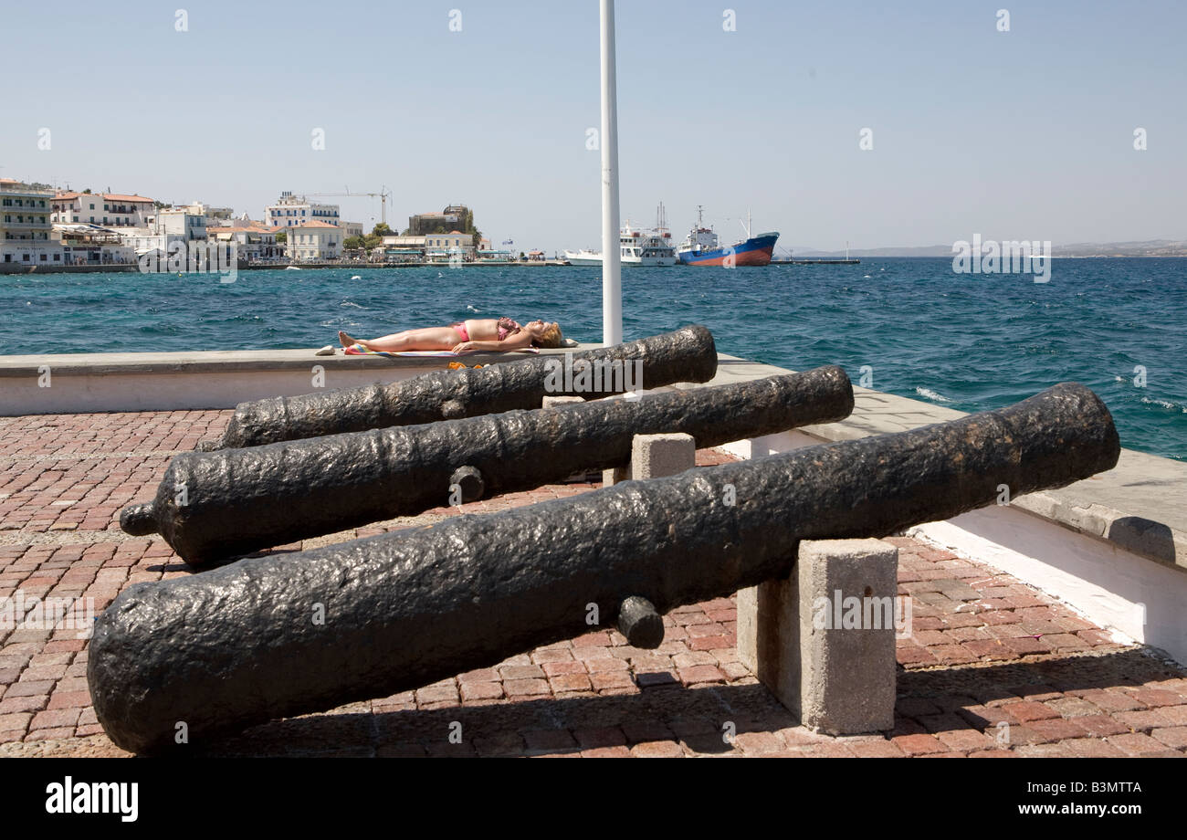 Woman Sunbathing With Cannons, Spetses, Greece, Hellas Stock Photo