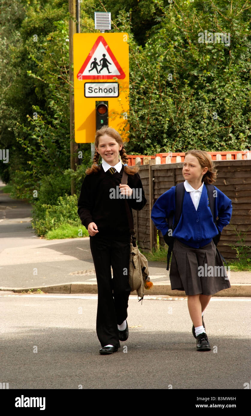 Schoolgirls in uniform walking from school England UK Stock Photo