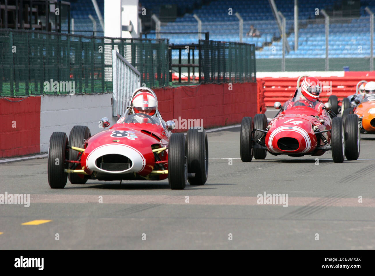 two red racing cars crossing the starting line Stock Photo