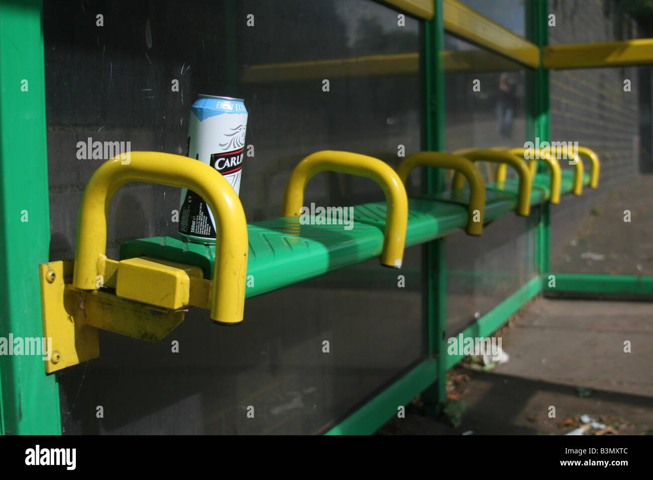 Discarded Carling beer can on bus stop seat in Coventry, England Stock Photo