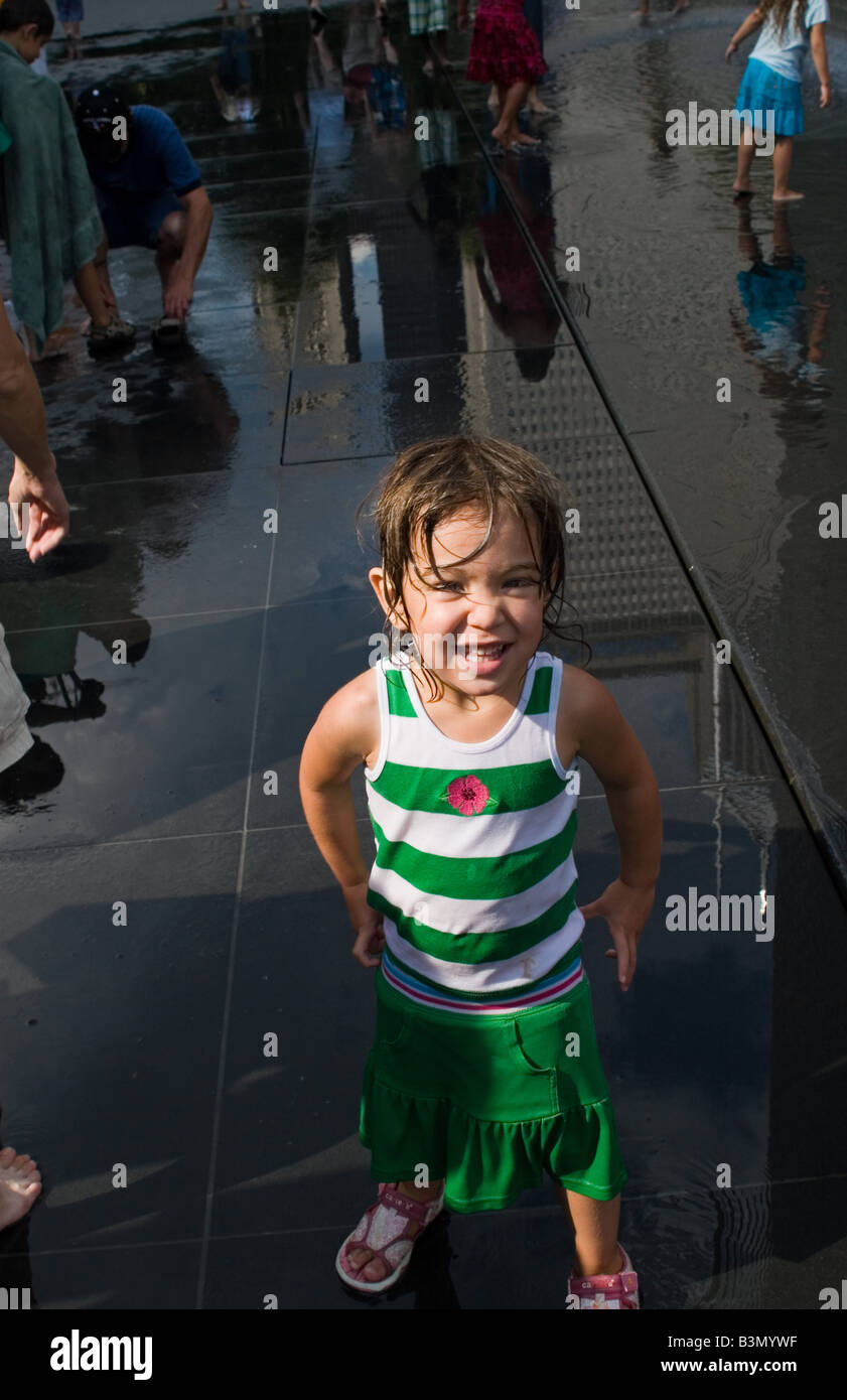 Smiling cute girl enjoying her day at Crown Fountain in Chicago's Millennium Park. Stock Photo
