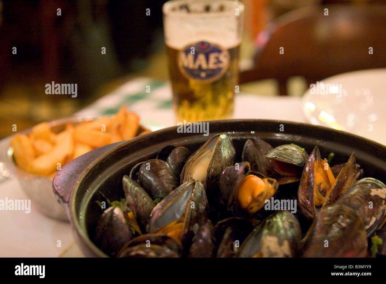Local speciality of 'Moules Frittes' mussels and chips in popular restaurant 'Leon' in Brussels