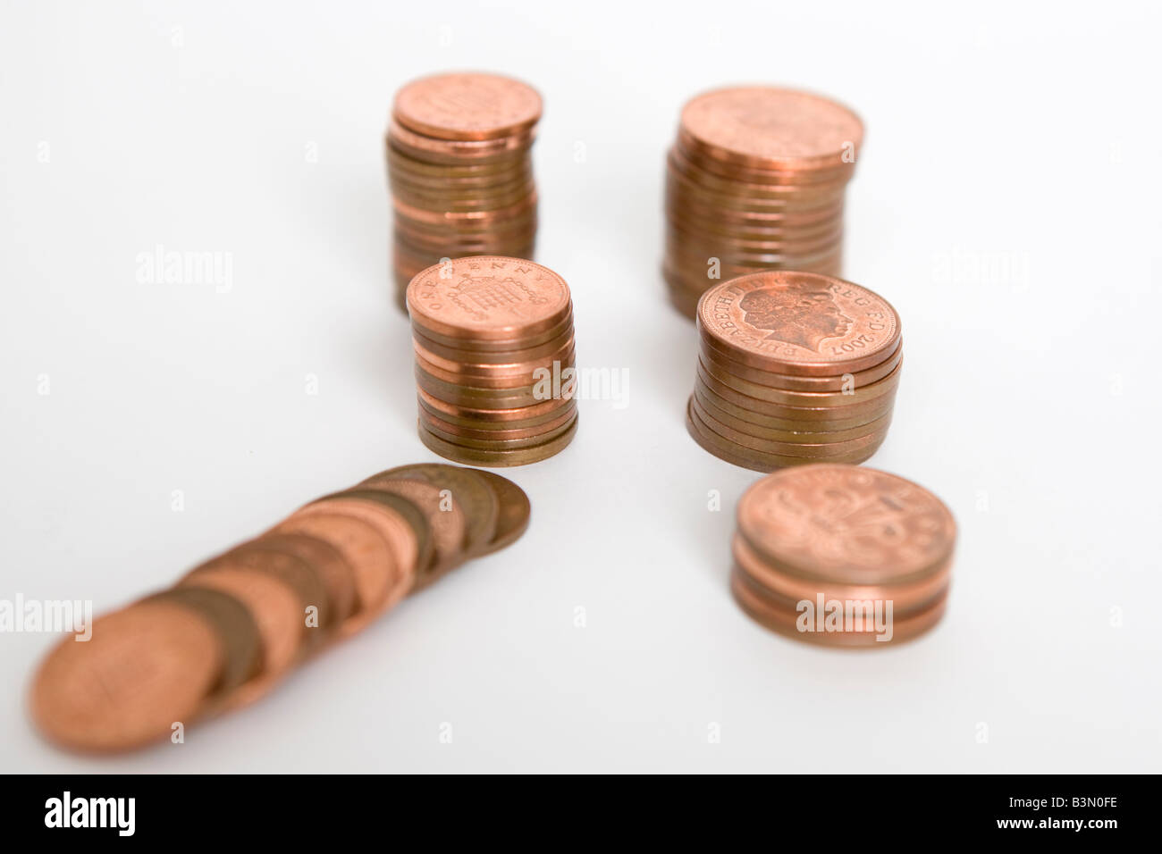 6 piles of 1 pence pieces or copper pennies Stock Photo
