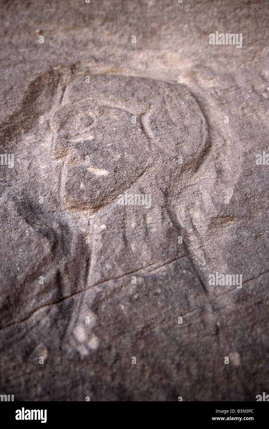 Rock carving depicts a man's portrait at an under-hang in a mountain at Wadi Al Hayat, Fezzan, Libya. Stock Photo