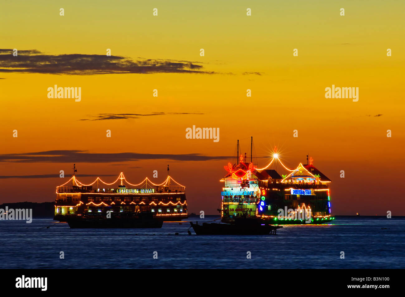 Floating sea food restaurants in Pattaya Bay at sunset Stock Photo