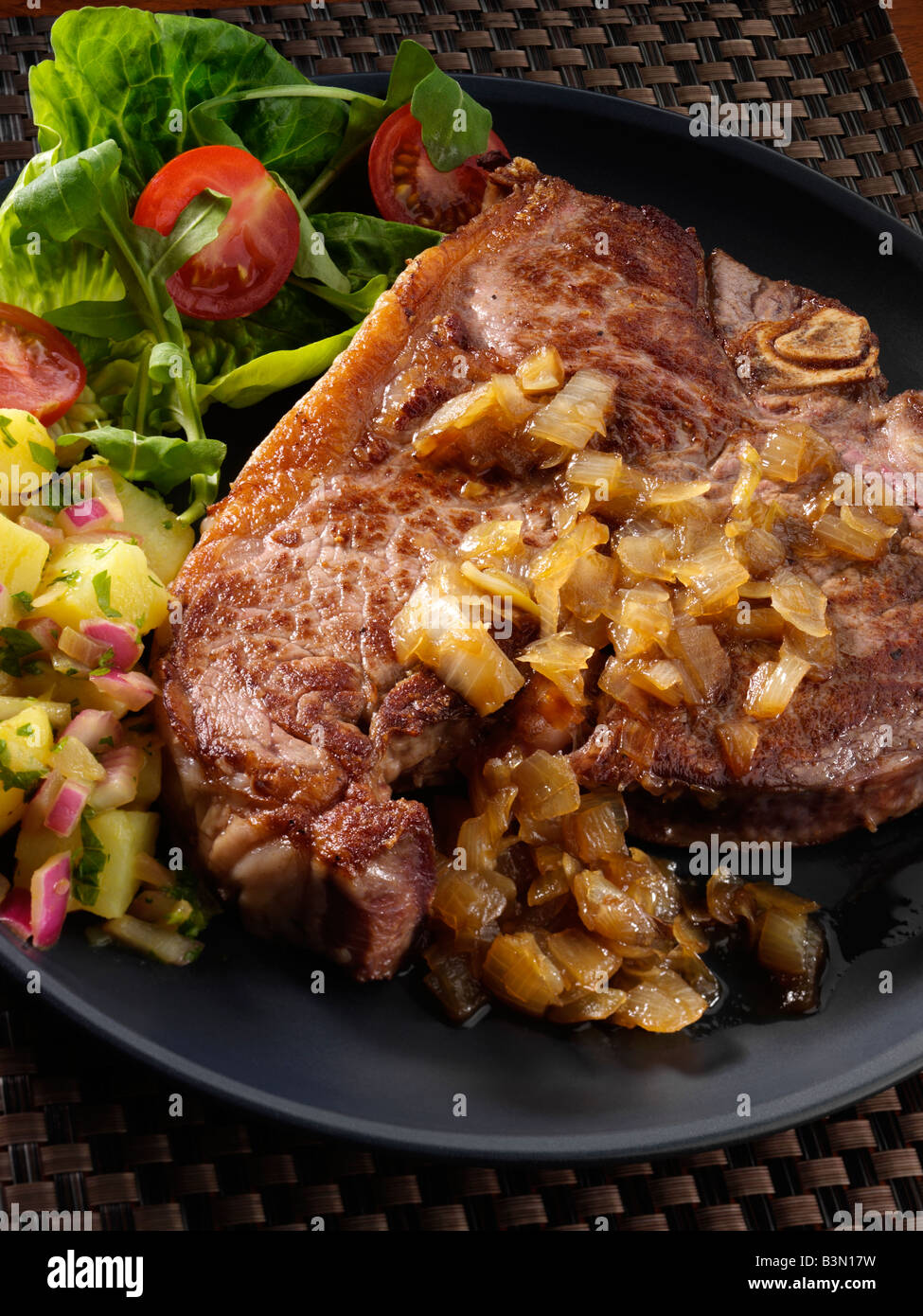 T bone steak and potato salad editorial food Stock Photo - Alamy