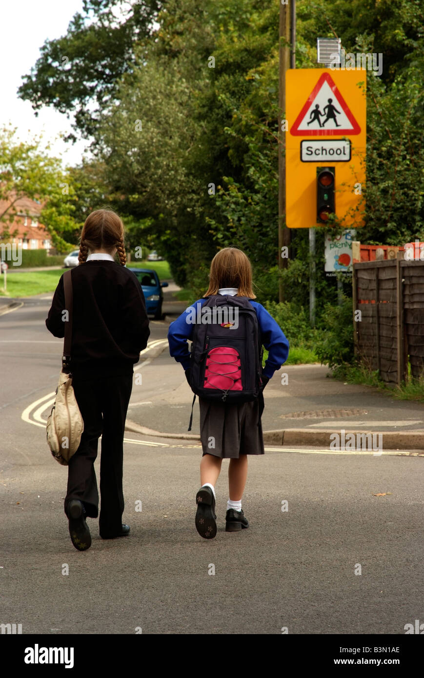 Schoolgirls in uniform walking to school England UK Stock Photo - Alamy