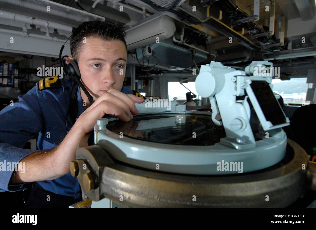 Officer of the watch on the bridge taking compass bearings Type 23 Duke