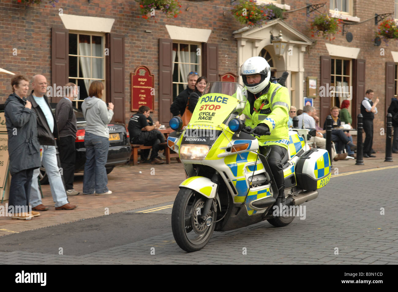 A police motorcyclist escorting the tour of Britain Cycle Race Stock Photo