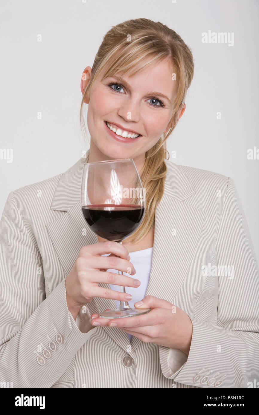 Young woman holding a glass of red wine, portrait Stock Photo - Alamy