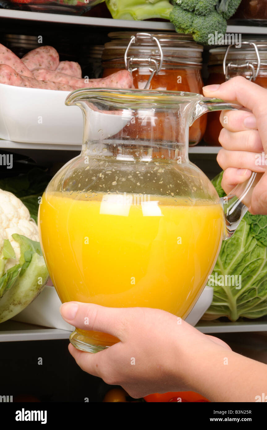 https://c8.alamy.com/comp/B3N25R/taking-jug-of-fresh-orange-juice-from-refrigerator-B3N25R.jpg