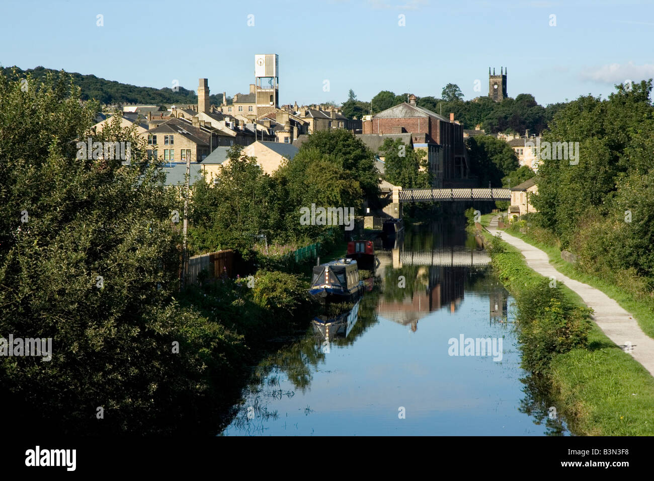 The skyline of the West Yorkshire town of Shipley, Bradford,  is reflected in the Leeds-Liverpool canal Stock Photo