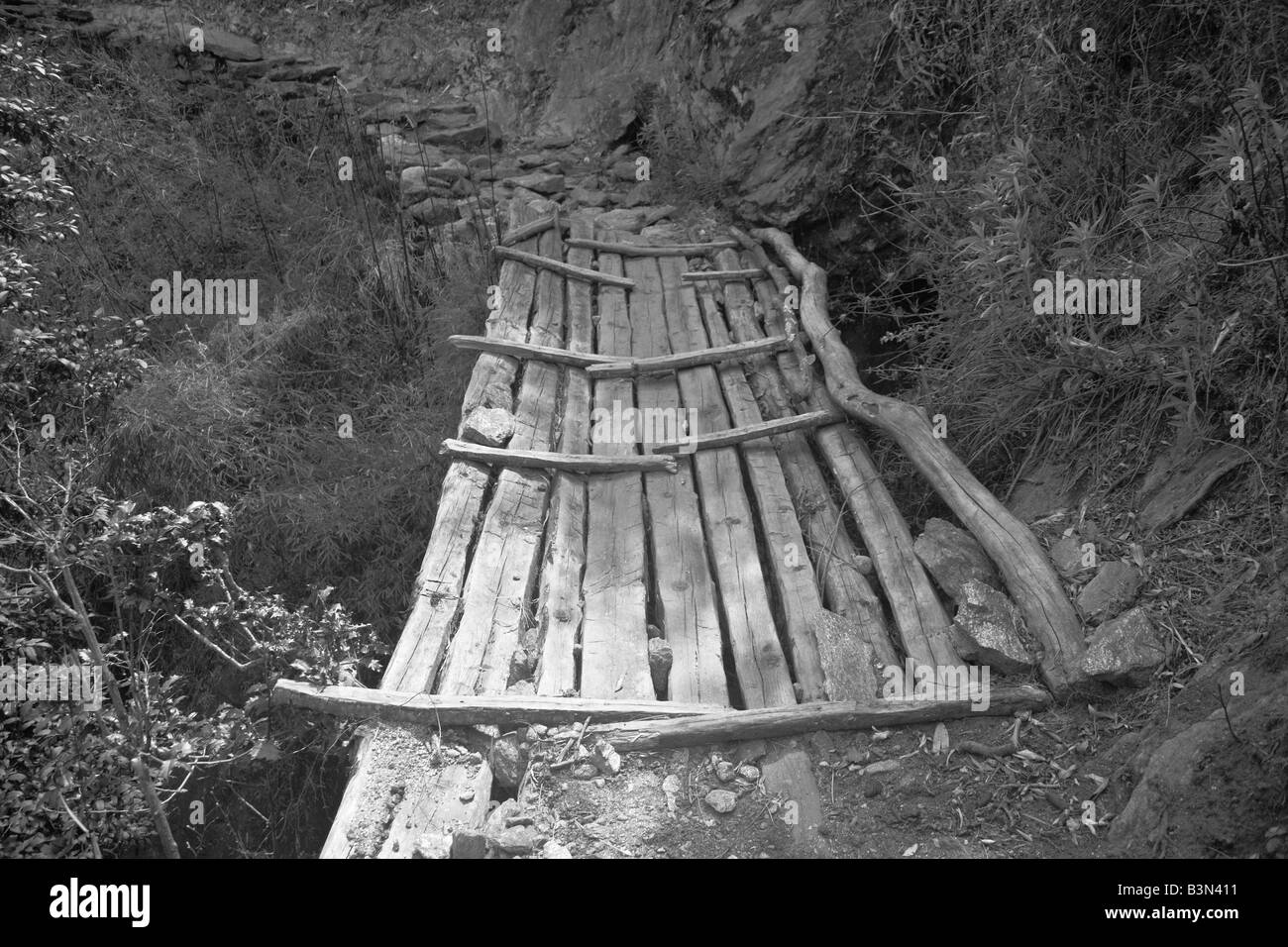 Wooden bridge over stream Stock Photo - Alamy