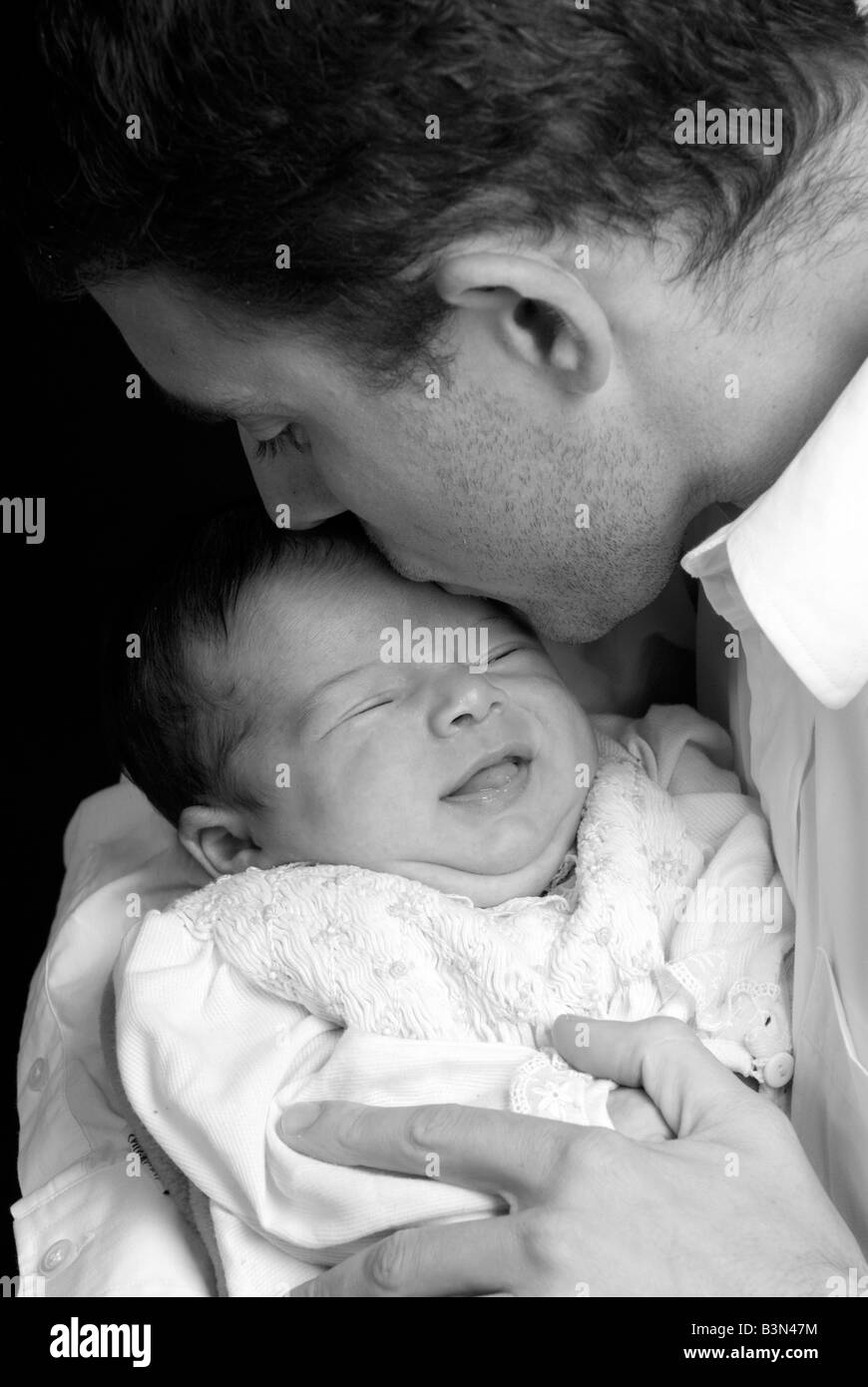 A young man with a newborn girl Family love caring Stock Photo