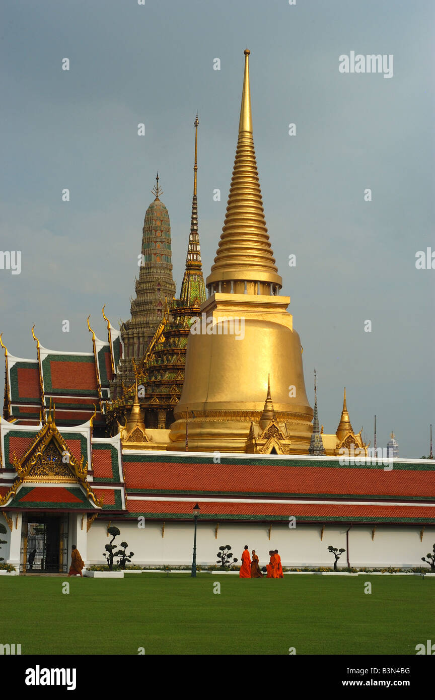 The Grand Palace Bangkok, Thailand. Travel Asia monks Buddhism Saffron orange robes towers spires Stock Photo