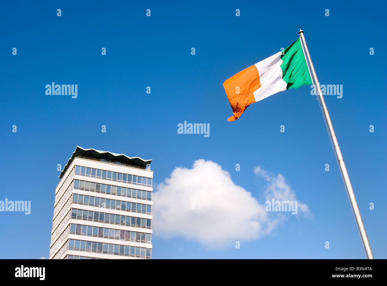 Building and Irish flag on flag pole against bright blue sky in Dublin, Ireland Stock Photo Alamy