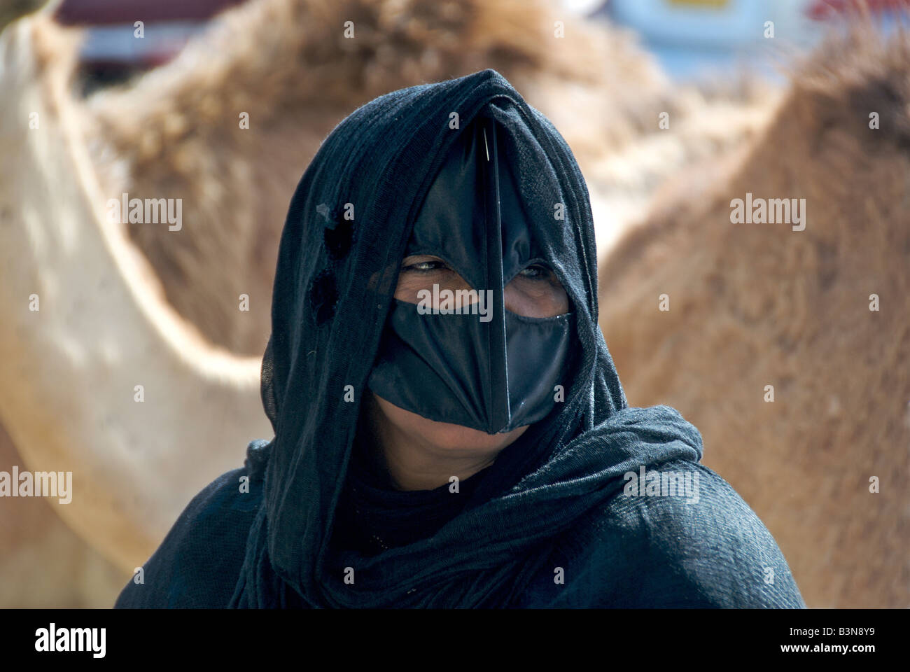 Close up Bedouin woman wearing black burka Sinaw Sharqiya Region Sultanate of Oman Stock Photo