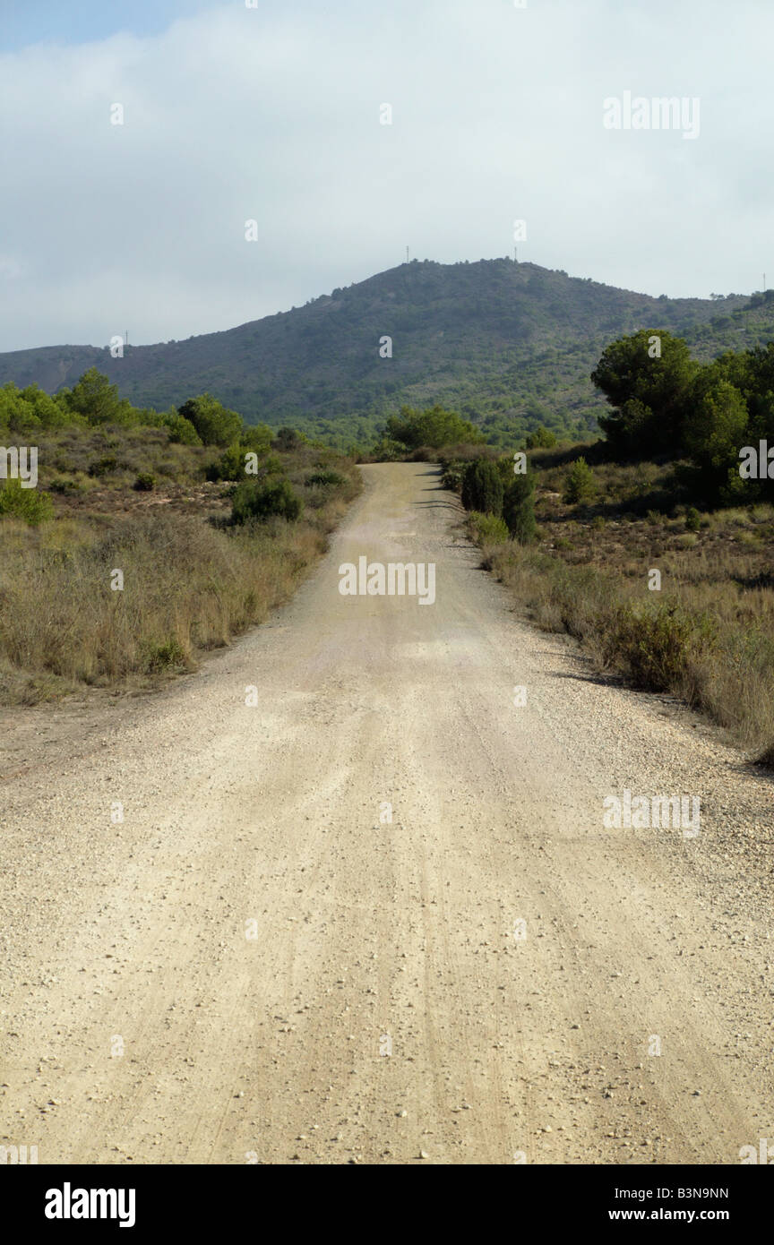 dirt gravel graval road with hill in distanc in mountains of spain in