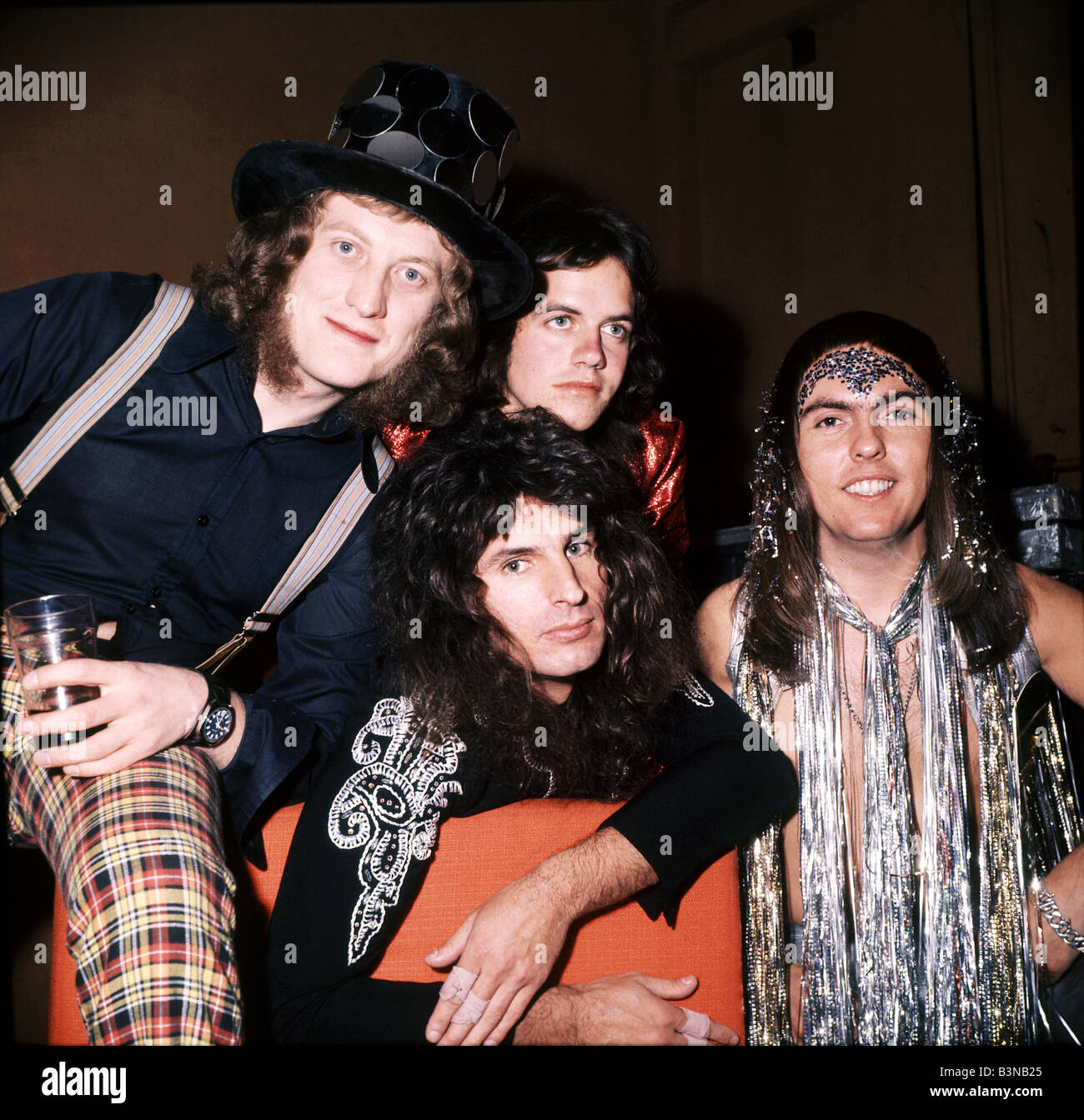 SLADE  UK glam rock group in 1973 with from left Noddy Holder, Jimmy Lea, Dave Hill and Don Powell seated Stock Photo