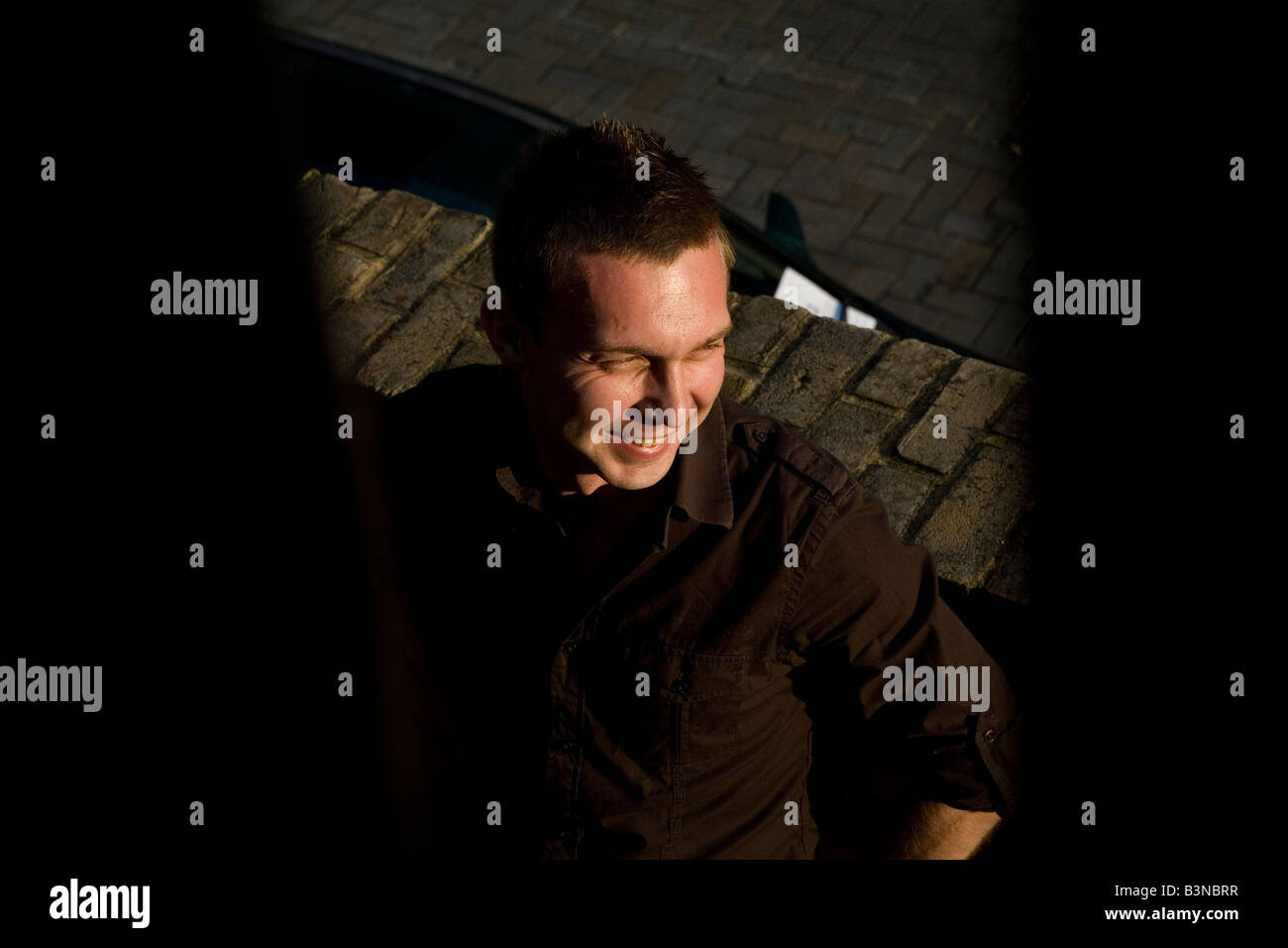a portrait of a young handsome business man male posing and looking at ...