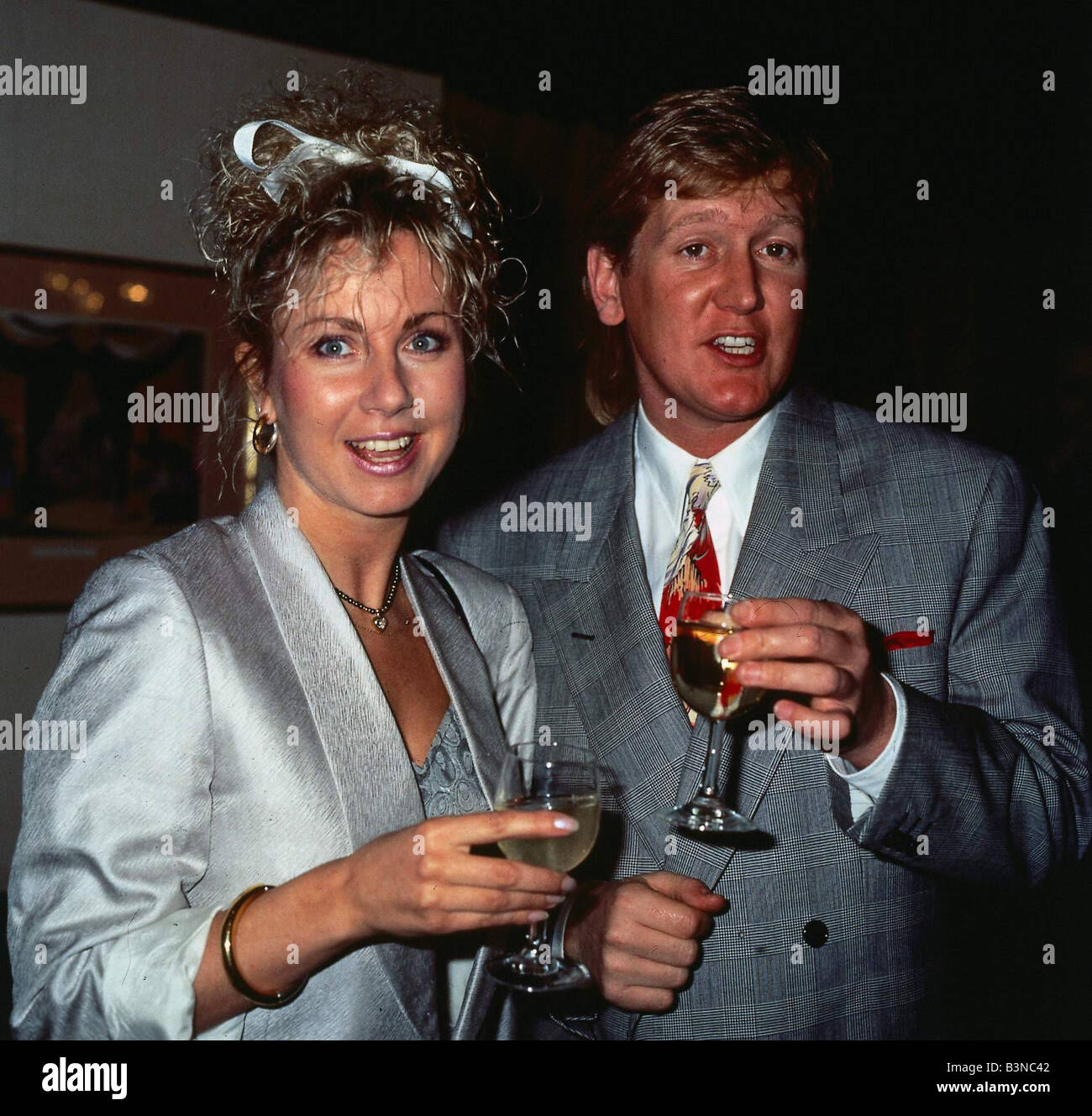 Mike Smith DJ disc jockey TV presenter with Sarah Greene holding glasses of champagne drink mirrorpix Stock Photo