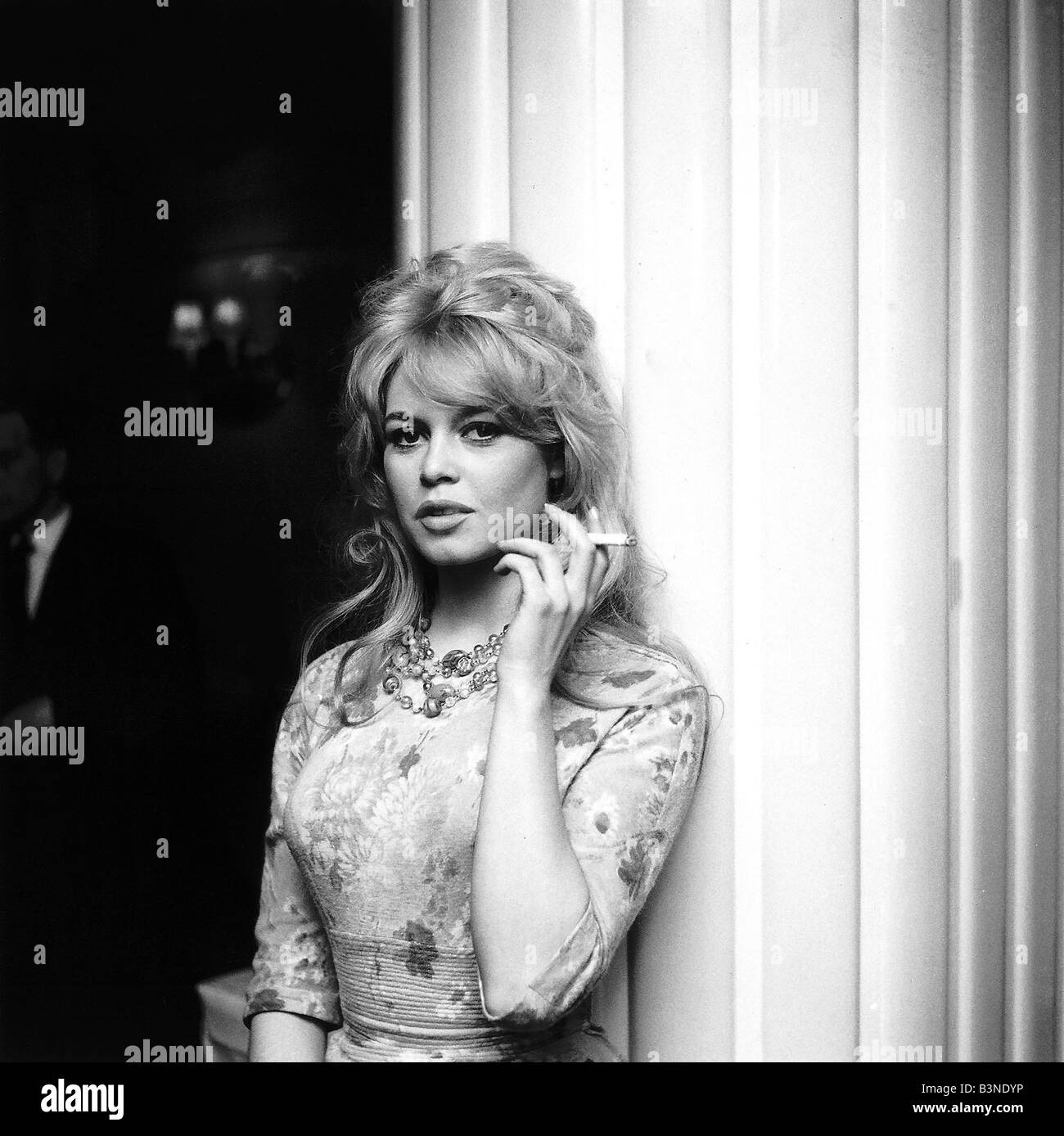 Brigitte Bardot actress smoking a cigarette upon arrival in London