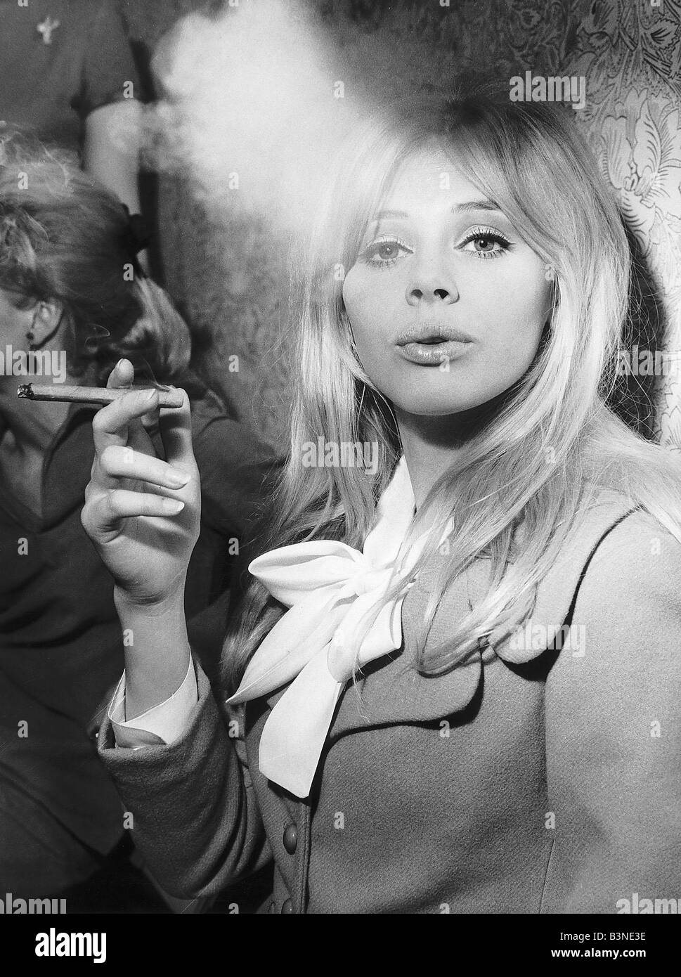 Britt Ekland Actress pictured enjoying the cigar at the Ideal Home Exhibition in London Stock Photo