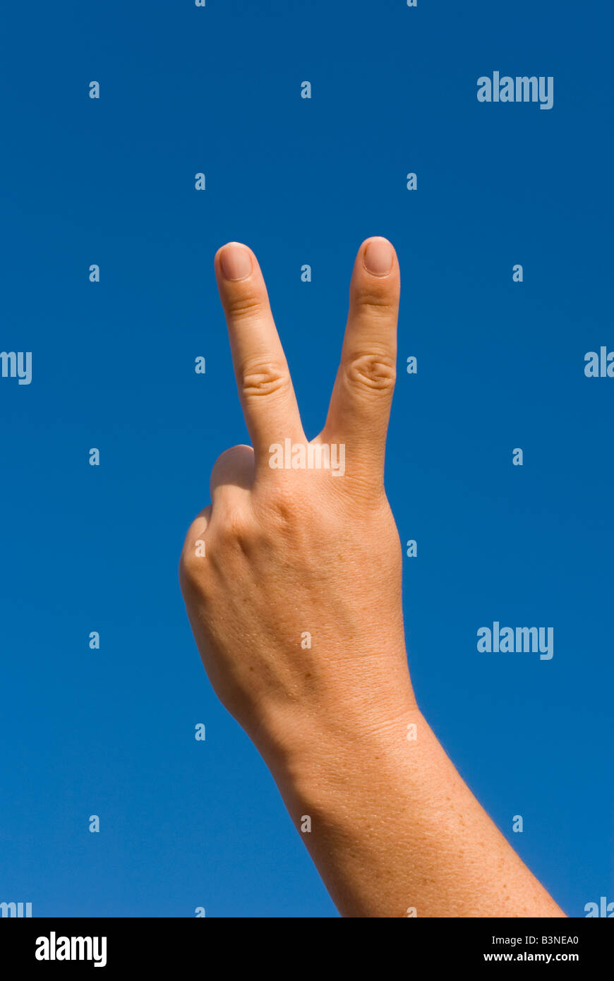 Model Released Detail of female forming an abusive V sign Stock Photo