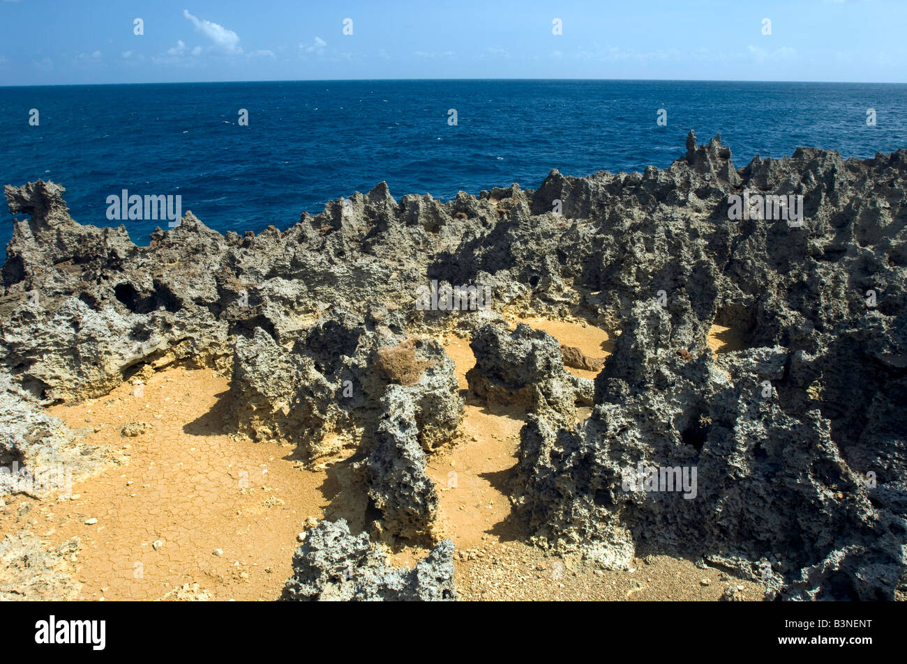 Eroded limestone with ocean in the background Stock Photo