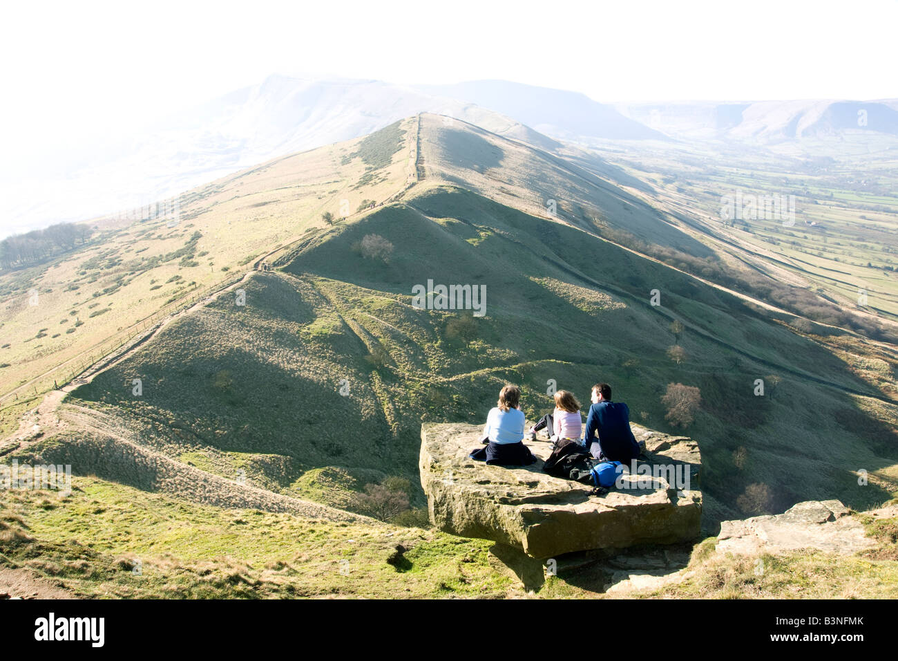 family of walkers on back tor looking towards mam tor in the peak district Stock Photo