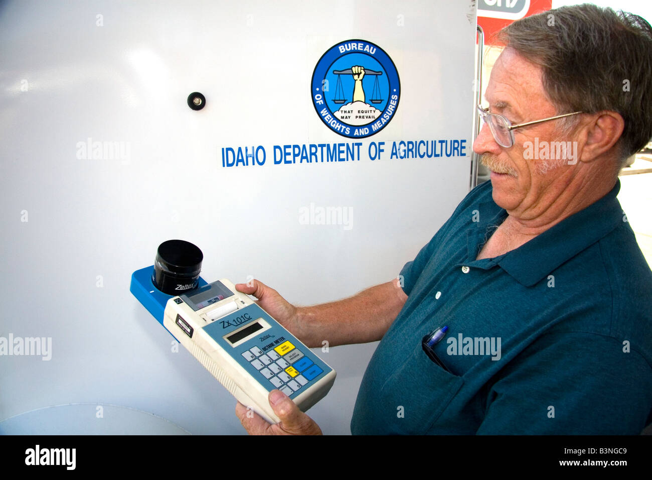 Bureau of Weights and Measures inspector using a device to determine gasoline octane rating in Boise Idaho Stock Photo