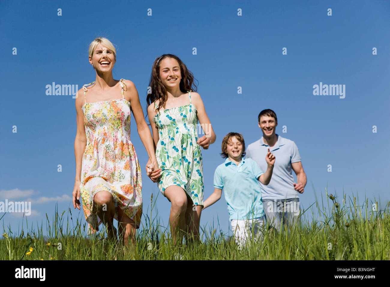 Germany, Baden Württemberg, Tübingen, Family walking in meadow Stock Photo