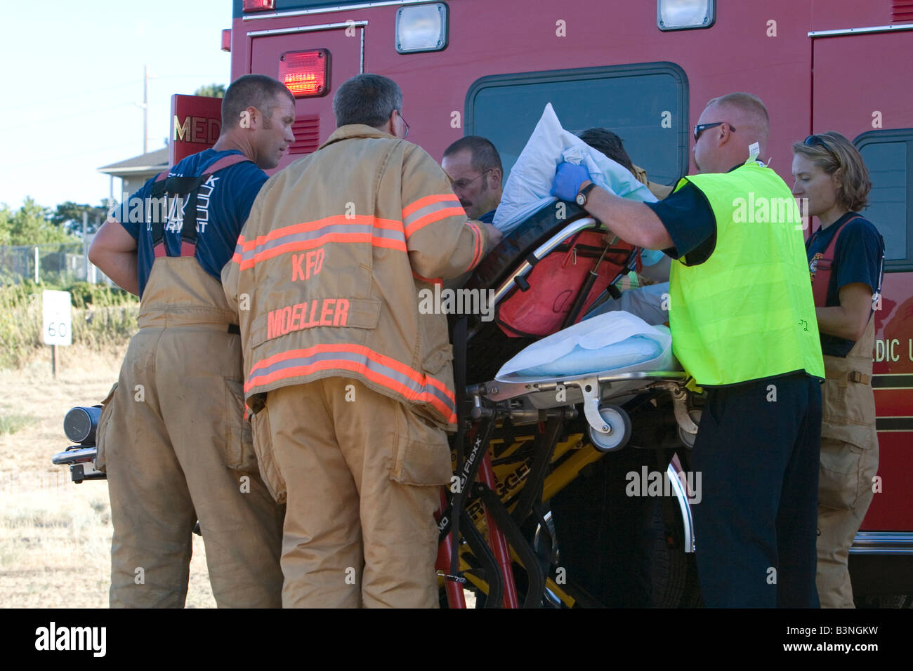 Paramedics providing emergency medical treatment to a person involved in a car accident at Kennewick Washington Stock Photo
