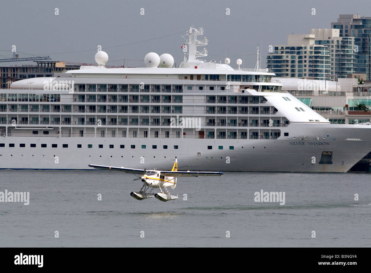 Seaplane taking off in front of the Silversea Silver Shadow cruise ship