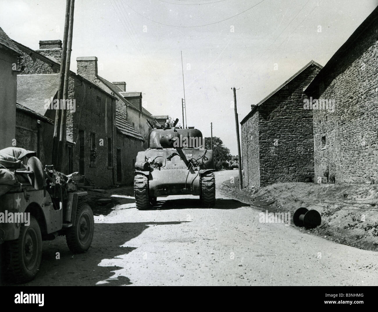 D-DAY 6 June 1944.  - Sherman tank passing through a French village Stock Photo