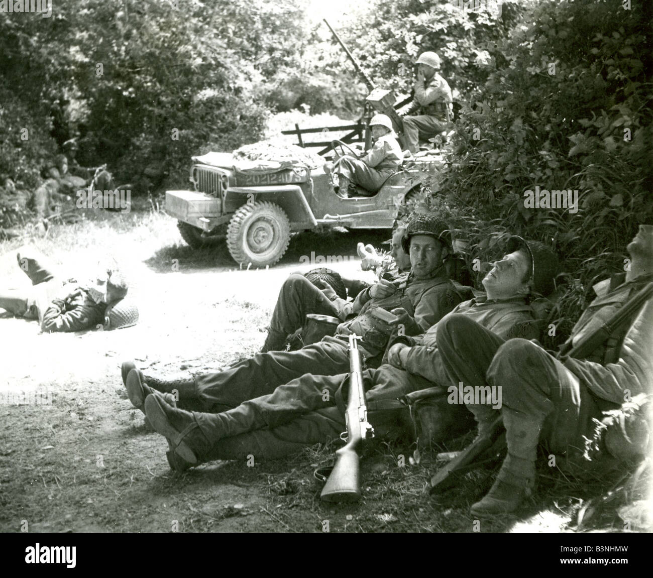 NORMANDY LANDINGS  US troops take a rest shortly after the landings on 6 June while an anti-aircraft mounted Jeep keeps watch Stock Photo