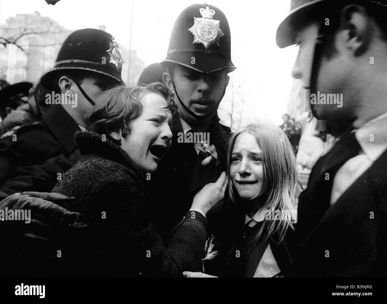 Upset Beatles fans crying because Paul McCartney got married are led away by police March 1969 Stock Photo