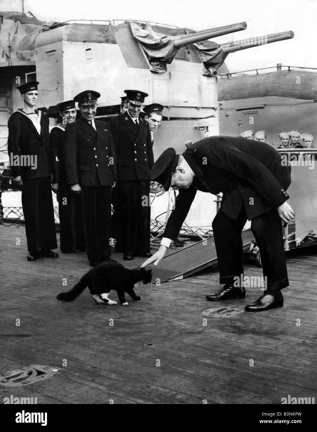 British Prime Minister onboard HMS Prince of Wales stroking black cat called Blackie who s a favourite on the ship August 1941 Stock Photo