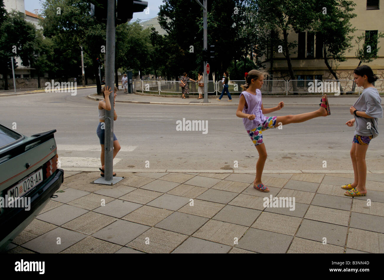 high kicking girls Mostar, june 1996', high kicking girl, croat children playing in the  street, 1996 Stock Photo - Alamy