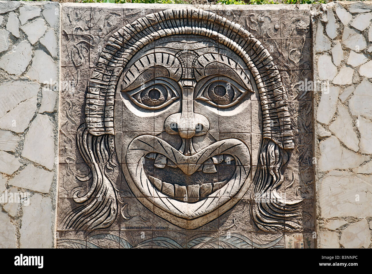 Italy, Calabria, Palmi, Province of Reggio Calabria, Viola Coast, Strait of Messina, Straits of Messina, mask at a wall, relief, grimace, visage, hideous face, snoot, mow, mowe, apotropaically, apotropaic, superstition, superstitiousness, bale, calamity, Stock Photo