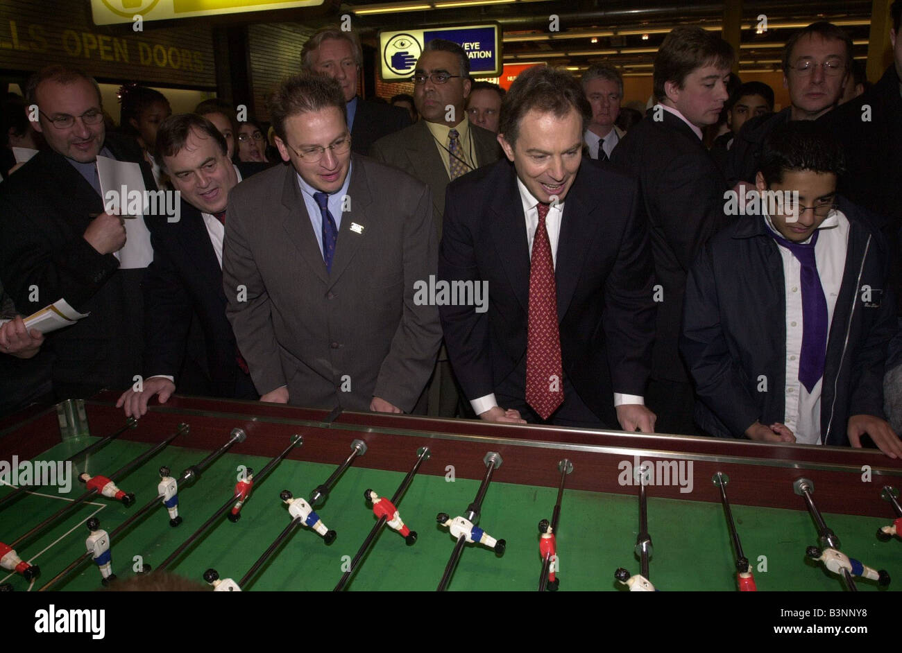 Tony Blair and Michael Heseltine December 2000 at the Millennium Dome to meet workers on the site Also there was Pierre Yves Gerbeau who ran the Dome Here playing table football with John Prescott watching Stock Photo