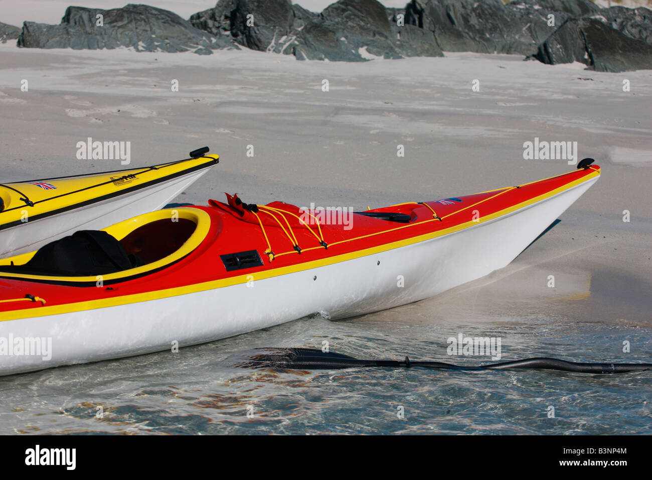 Red and yellow kayaks on the beach Stock Photo