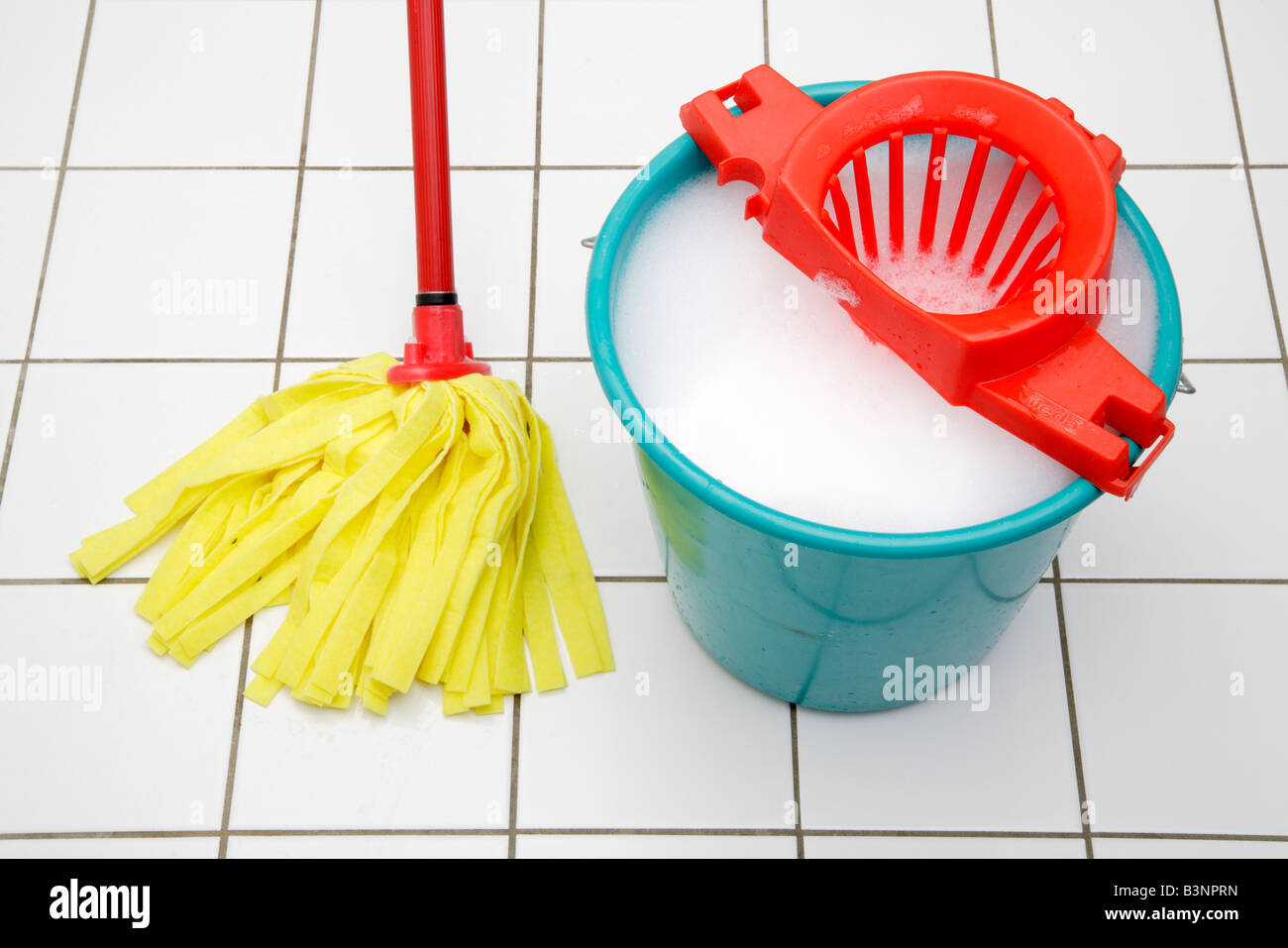 Display of plastic bucket containers and brooms and mops for cleaning  outside a small hardware shop Stock Photo - Alamy